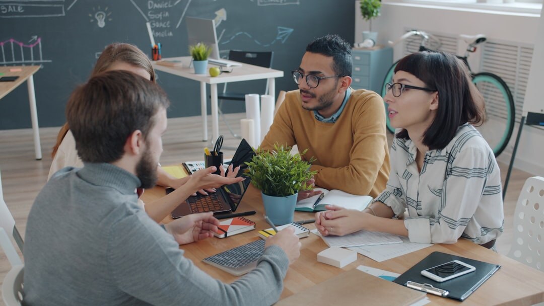 Group of people engaged in an animated discussion around a table